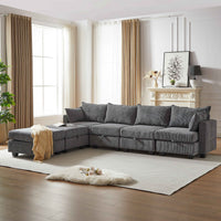 Large dark gray corduroy sectional sofa with plush seating, comfortably seats six people in a modern living room.