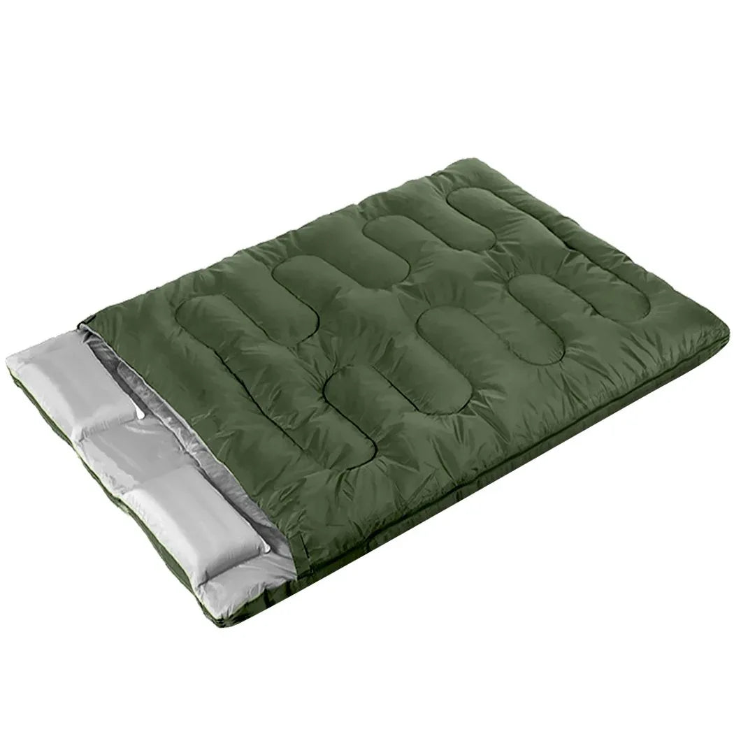 Blue double sleeping bag with unzipped side showing quilted interior on outdoor ground