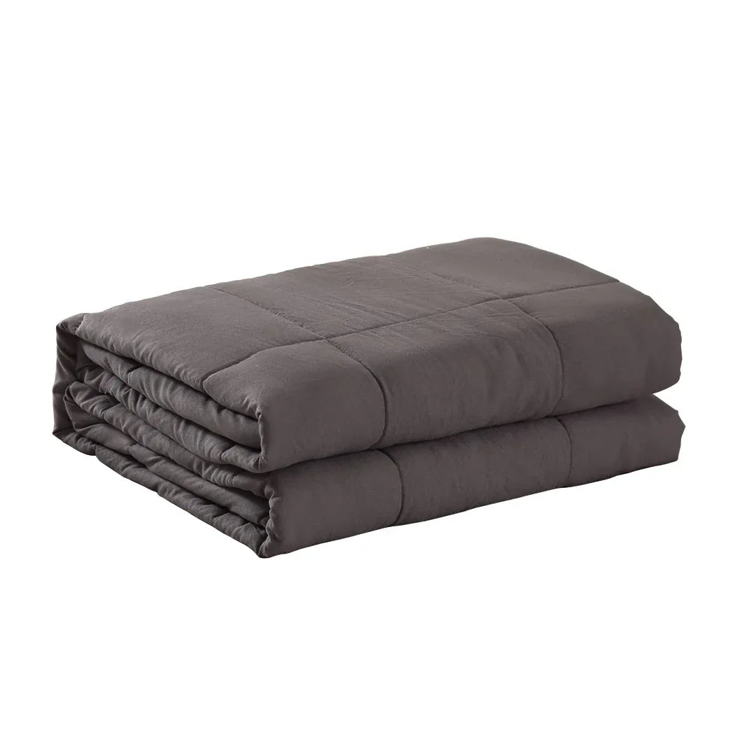 Grey DreamZ weighted blanket folded on bed, showing soft textured fabric and neat stitching.