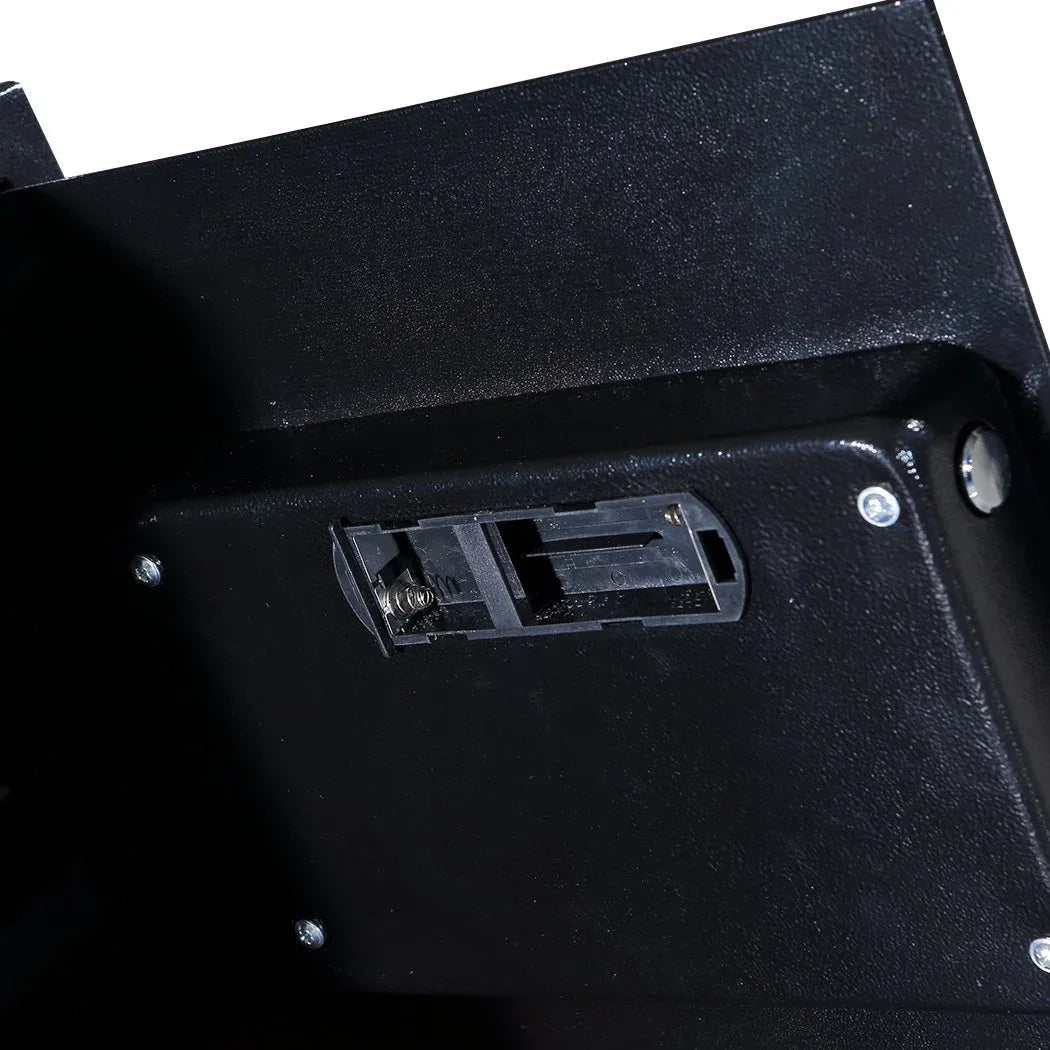 Close-up of electronic safe keypad with number buttons and small status screen.