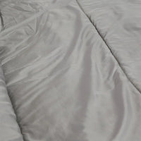 Sleeping bag rolled up and buckled for compact storage with carry handle