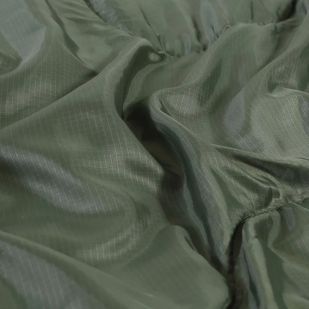 Sleeping bag folded and rolled with compression straps for easy portability.