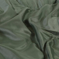 Sleeping bag folded and rolled with compression straps for easy portability.