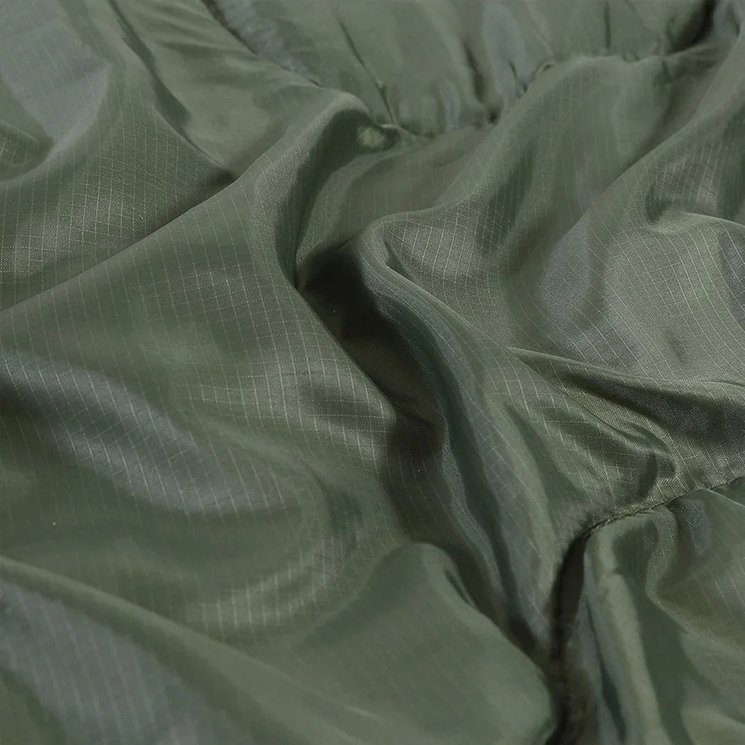 Partial view of sleeping bag zipper and fabric texture in blue and gray colors
