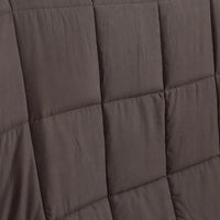 Hand pressing the plush surface of the DreamZ heavy weighted blanket showing softness.