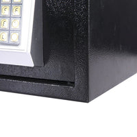 Hand entering code on electronic safe digital keypad for unlocking the safe.