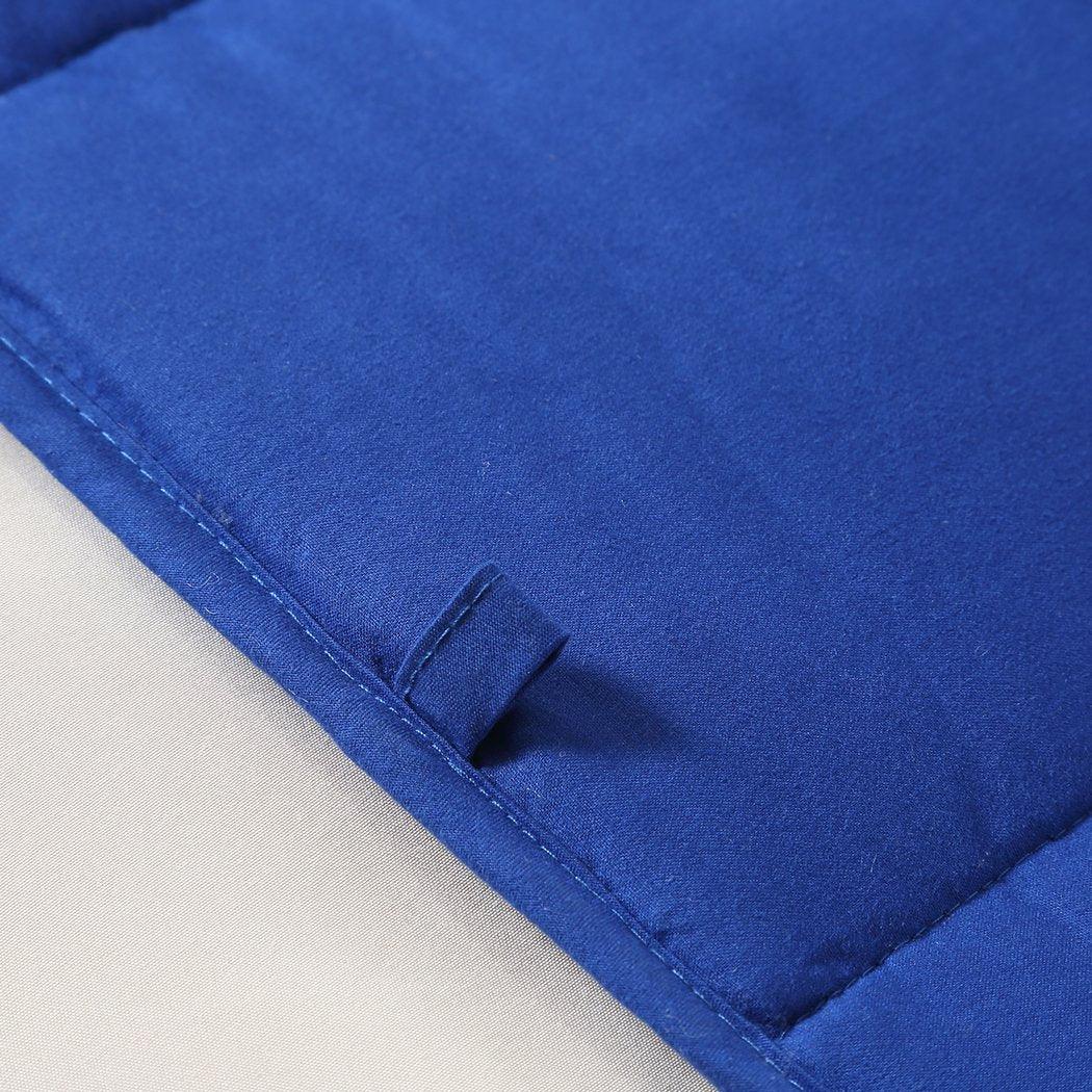 Weighted blanket spread out on a bed highlighting its insulation and quality stitching.