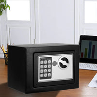 Electronic safe placed on office desk next to keyboard and documents for security.