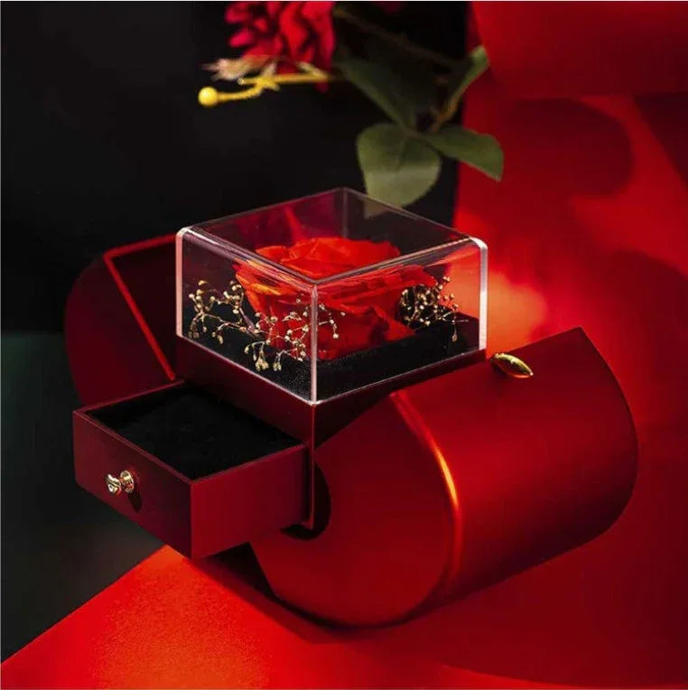 Fashion jewelry box shaped like red apple containing an eternal rose flower.