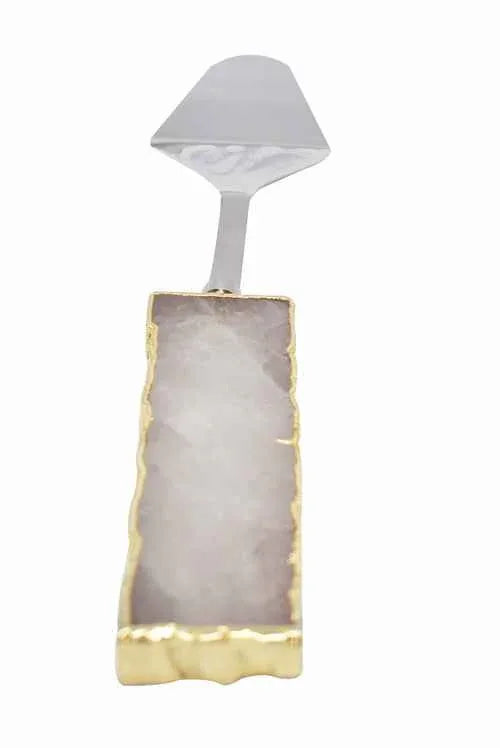 Clear quartz handle cake server with shiny gold trim on knife blade