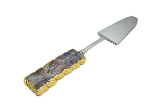 Amethyst gemstone cake server with gold trim displayed on white surface