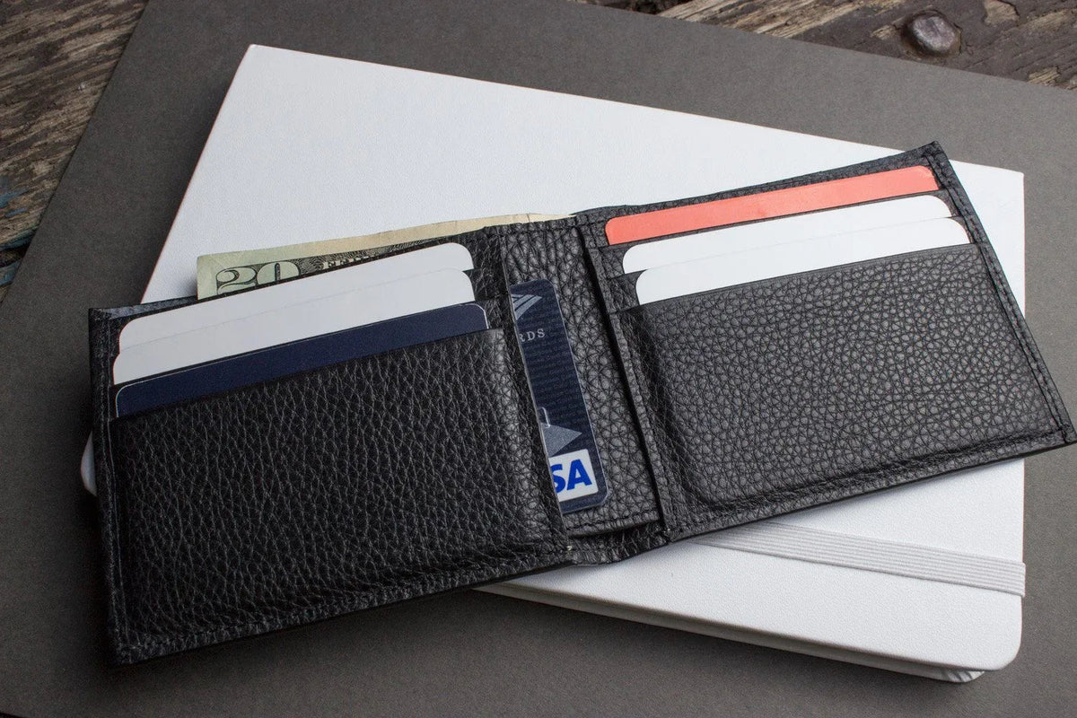 Black leather wallet opened to display six card slots and compartments.