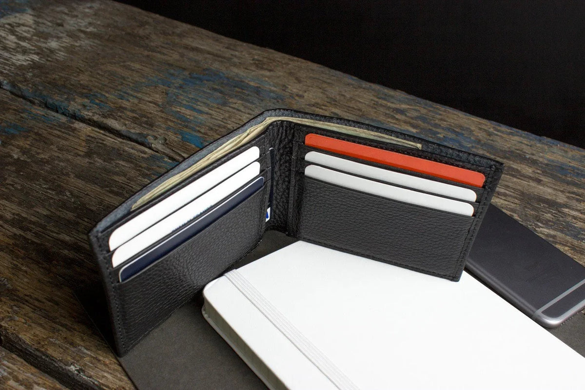 Side view of handmade black leather wallet showing slim profile.