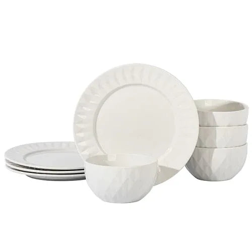 Close-up of white ceramic bowls and dinner plates with subtle geometric design in glossy finish.