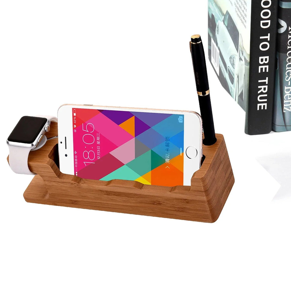 Mobile phone watch holder on a desk with cables and tech gadgets around.