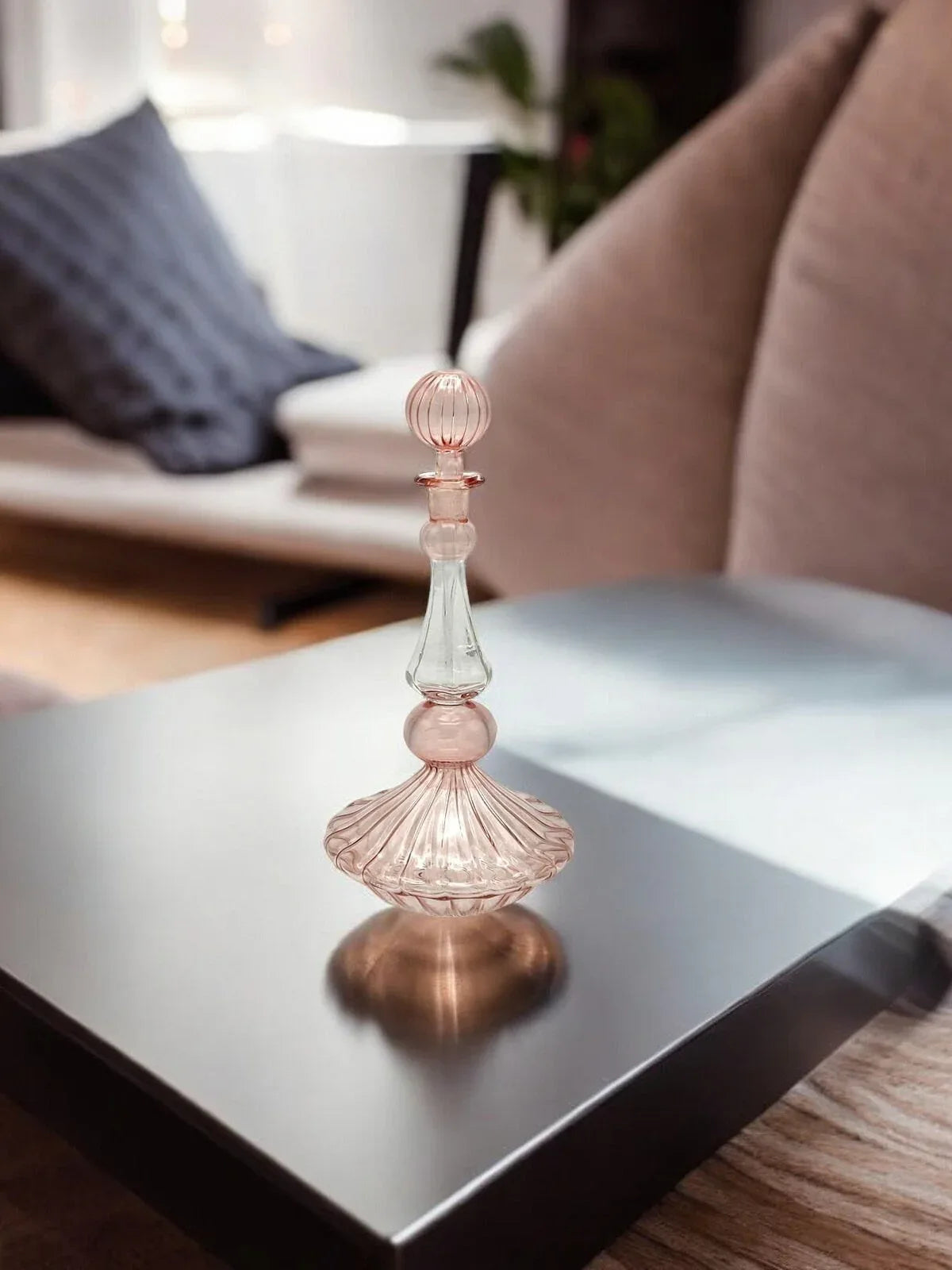 Delicate small glass perfume bottle featuring vibrant hand painted flowers and leaves.