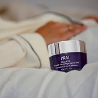 Smiling woman applying night cream on her throat and décolletage area
