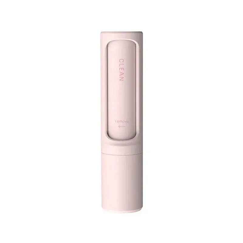 Reusable pet hair remover brush positioned showing handle and hair collection roller.