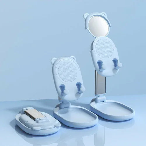 Pink and white phone holders shown side by side with mirrors and phone rests.