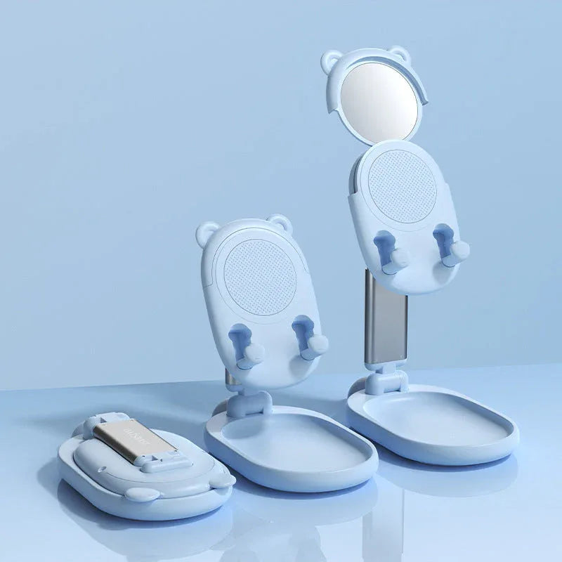 White phone stand showing non-slip silicone bottom pads on a wooden surface.