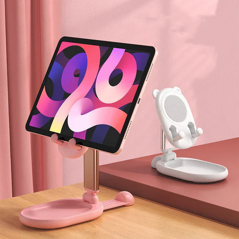 Pink desk phone holder unfolded, holding a smartphone in landscape orientation.