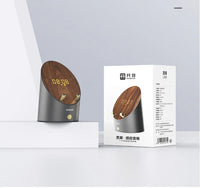 Technical illustration highlighting clock function and induction area of the wooden speaker