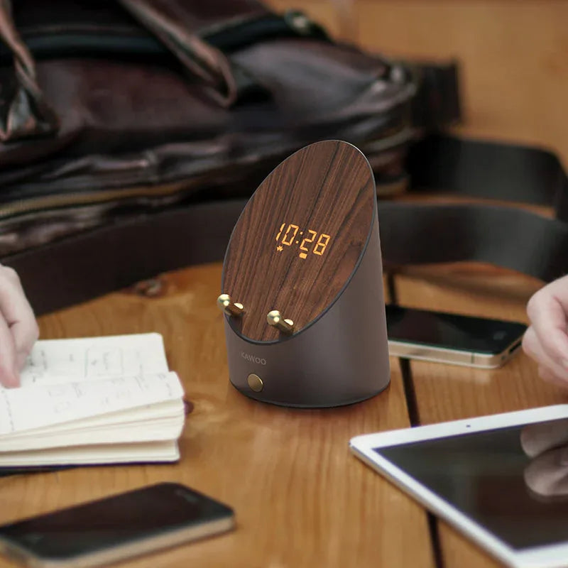 Side view of wooden smart induction speaker phone holder with phone placed upright