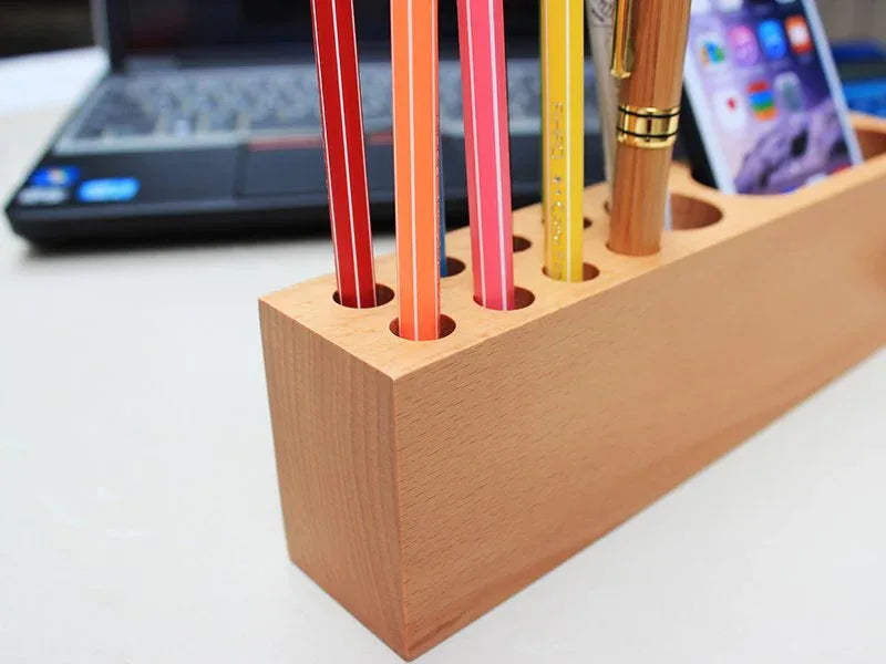 Wood phone holder and pen container set on white surface, highlighting compact design and wood grain.