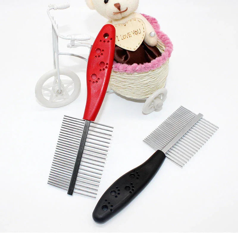 Hand holding red pet grooming comb demonstrating comfortable grip and round needles