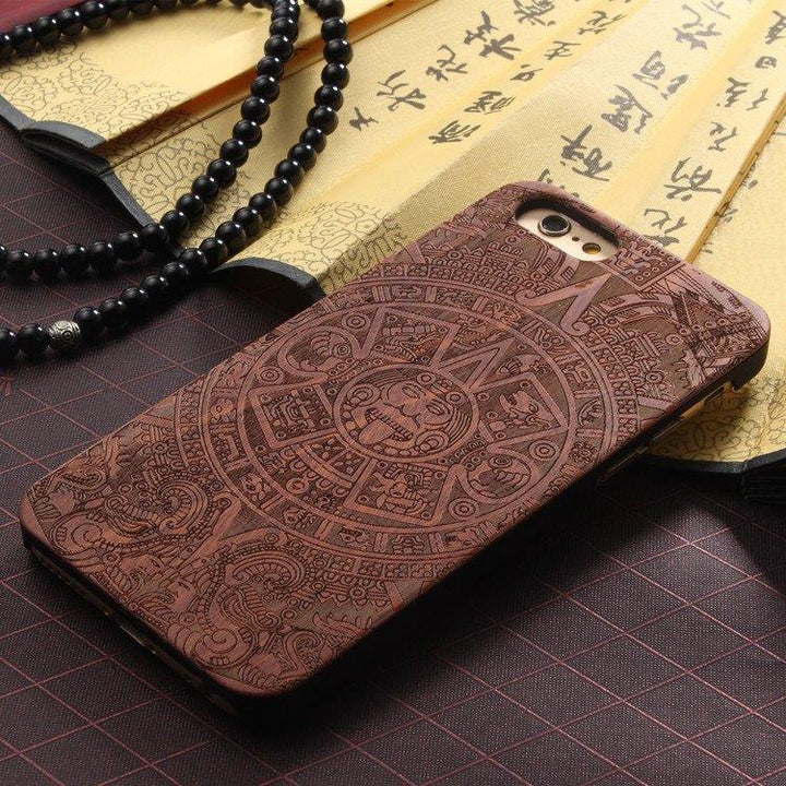 The Aztec Calendar iPhone case featuring intricate wood and black plastic design on a white background.