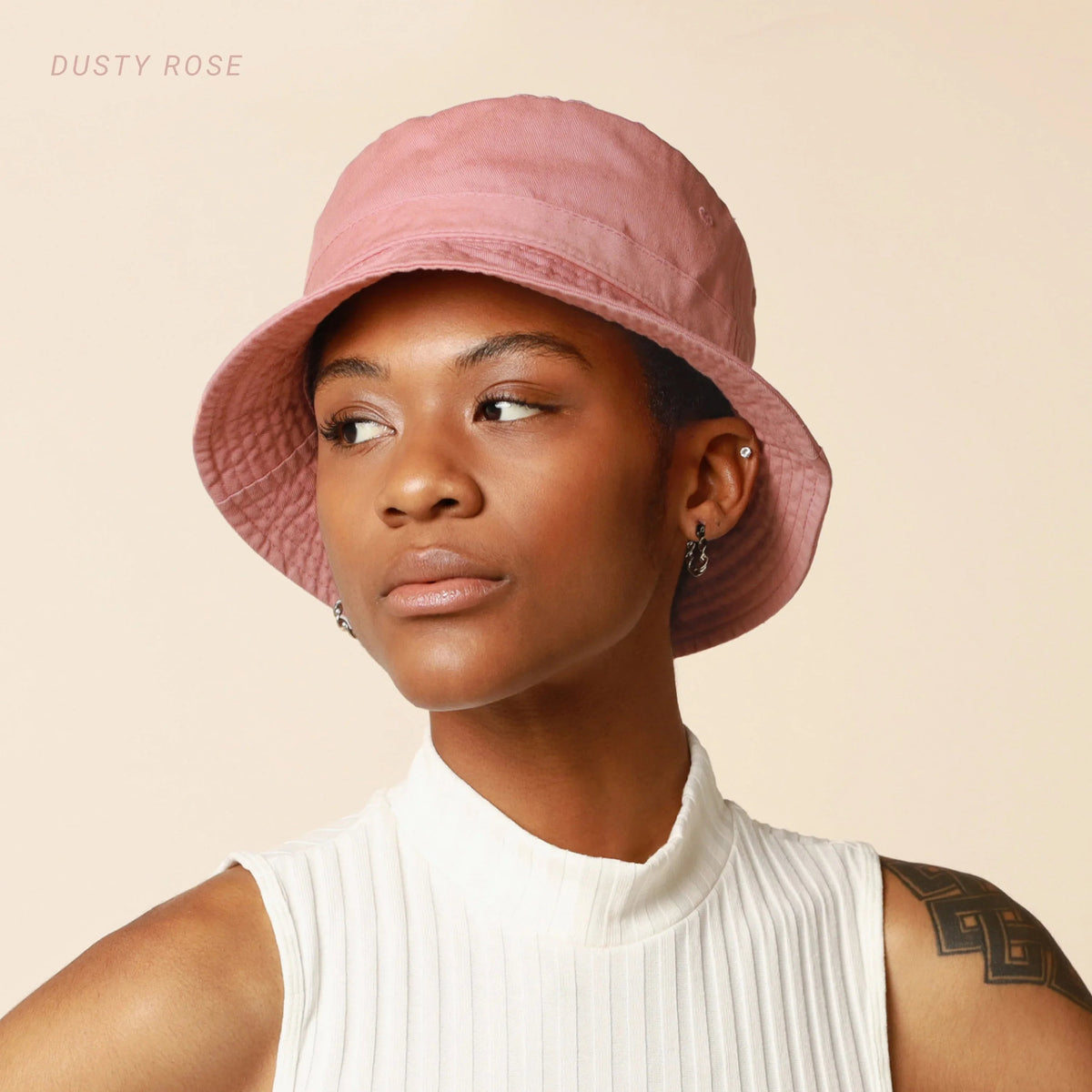 Model wearing dark brown cotton bucket hat with flat brim, facing forward.