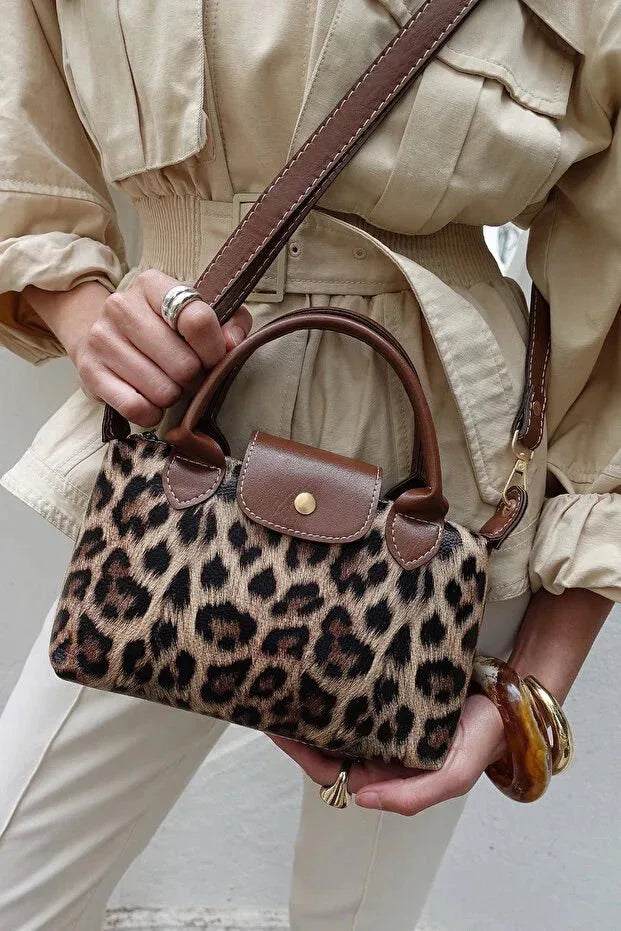 Crossbody bag worn across the body demonstrating comfortable fit and compact size.