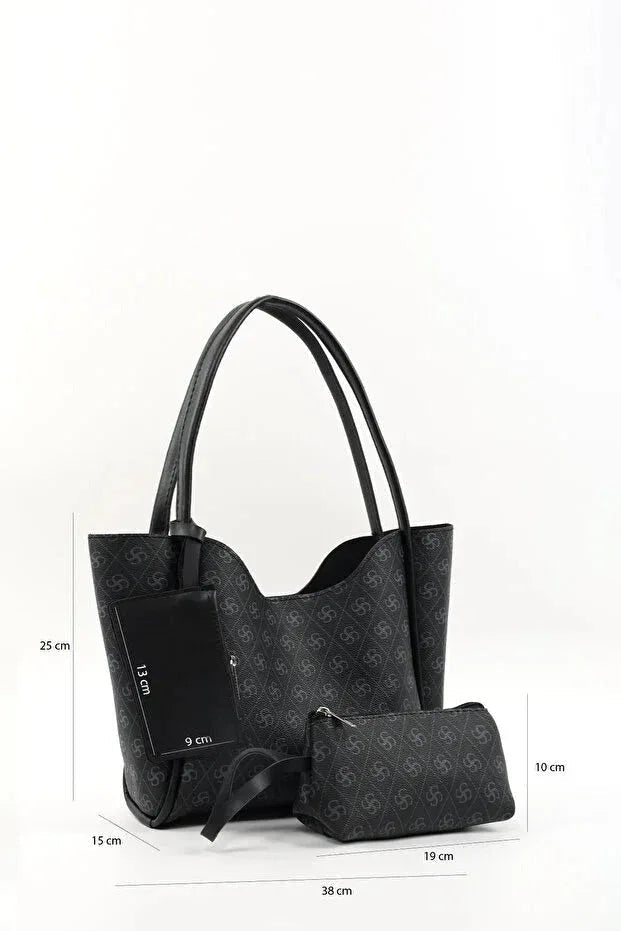Black faux leather hand and shoulder bag with gold hardware and monogram pattern on front.