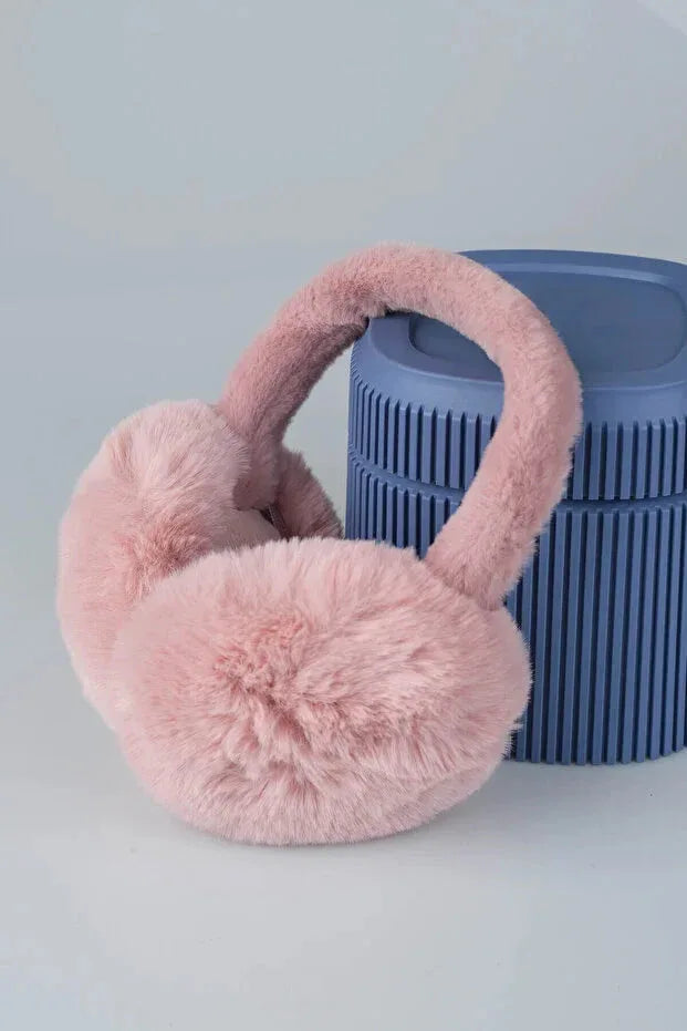 Close-up of soft pink plush earmuffs highlighting the thick, cozy padding and smooth exterior.