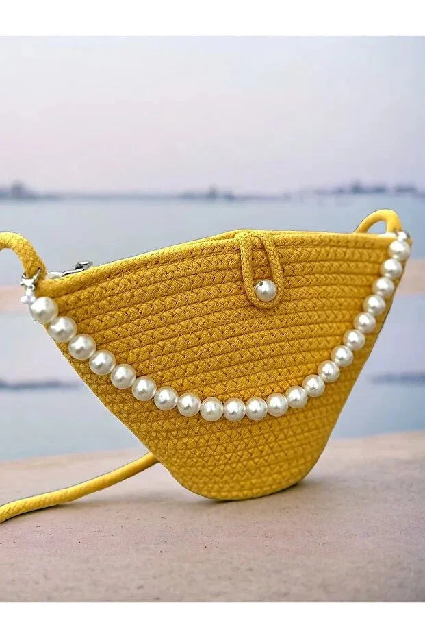 Yellow pearl design handbag showing texture and stitching details