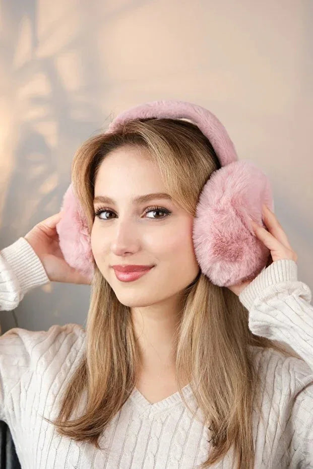 Soft pink plush earmuffs displayed flat, showcasing their foldable design and fluffy texture.