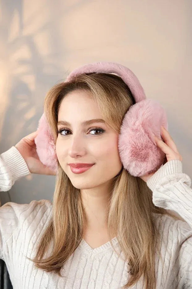 Detailed view of the inner lining of soft pink plush earmuffs, showing softness and comfort features.