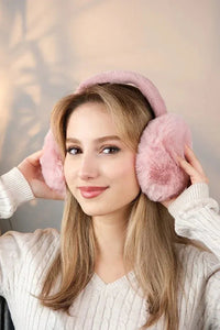 Detailed view of the inner lining of soft pink plush earmuffs, showing softness and comfort features.