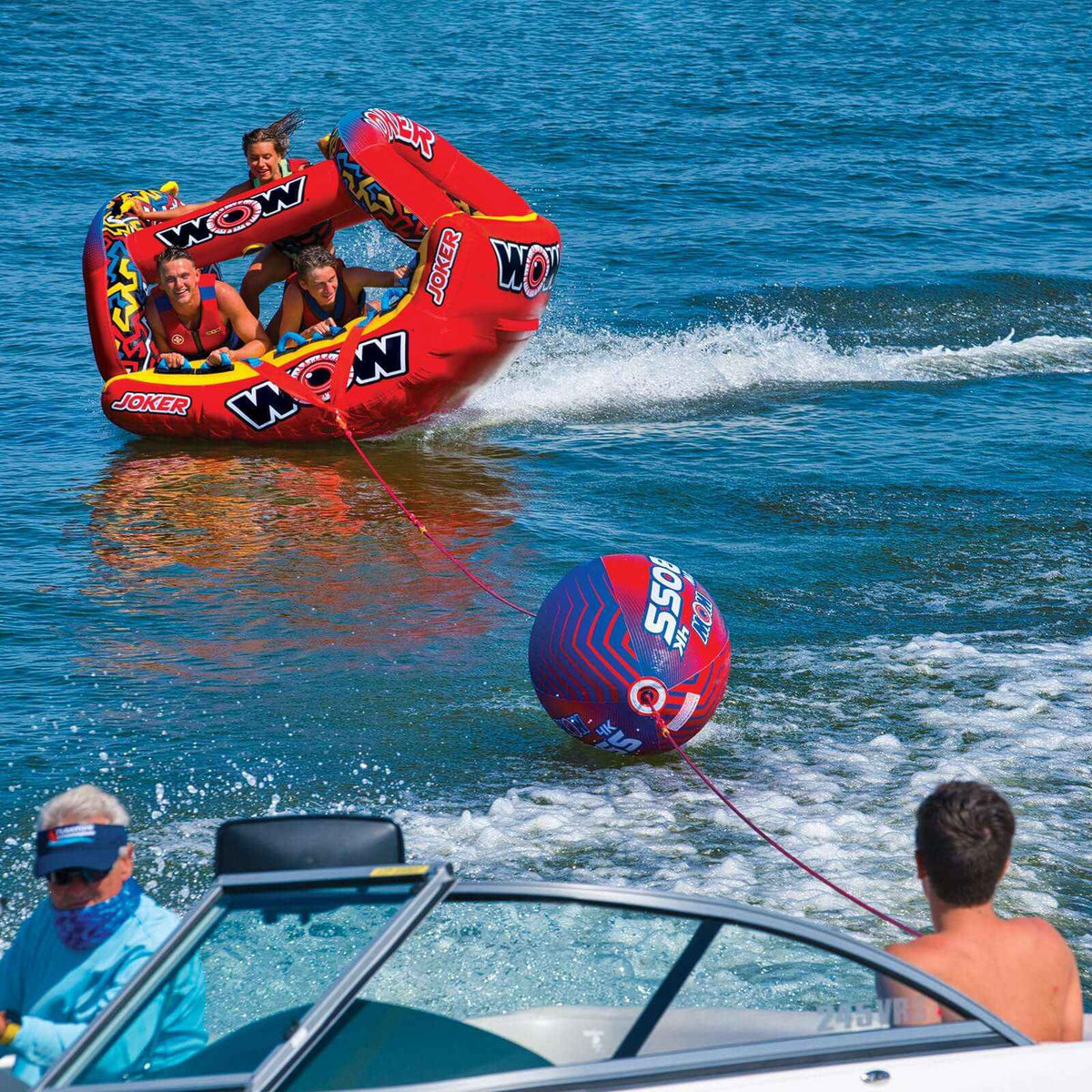 Hand gripping the bright orange inflatable Tow Boss, highlighting its sturdy design.