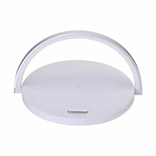 Black wireless charger block with phone stand, holding a smartphone upright on a white table.