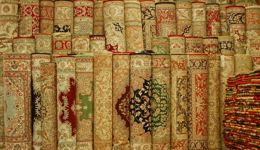 Rolled handwoven Turkish carpets — representative example (photo: shioshvili, Flickr, CC BY-SA)