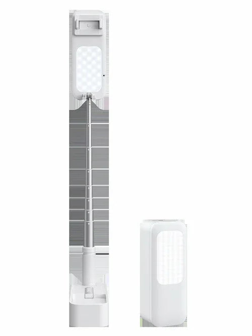 Selfie mobile phone holder with adjustable height on wooden surface in studio lighting.