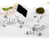 Close-up of flexible animal phone stand gripping a smartphone, showcasing its bendable design.