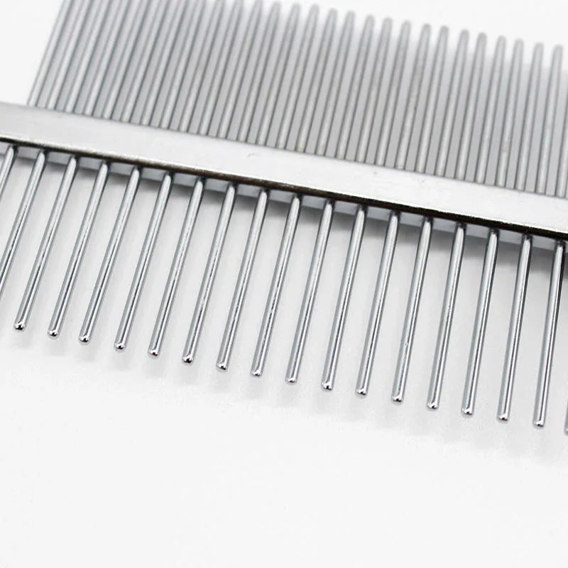 Close-up of red pet grooming comb showing dense and sparse stainless steel teeth and hollow handle design