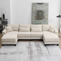 Large beige corduroy U-shaped sectional sofa with armrests, shown in a spacious living room setting.