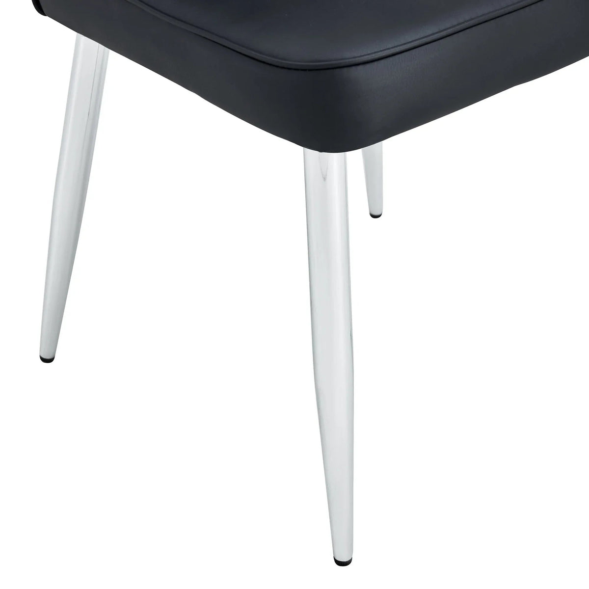 Set of black minimalist dining chairs arranged in dining room setting