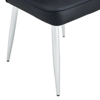 Set of black minimalist dining chairs arranged in dining room setting