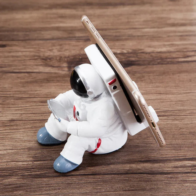 Astronaut phone stand angled showing its compact 10.6 by 7.3 cm size.