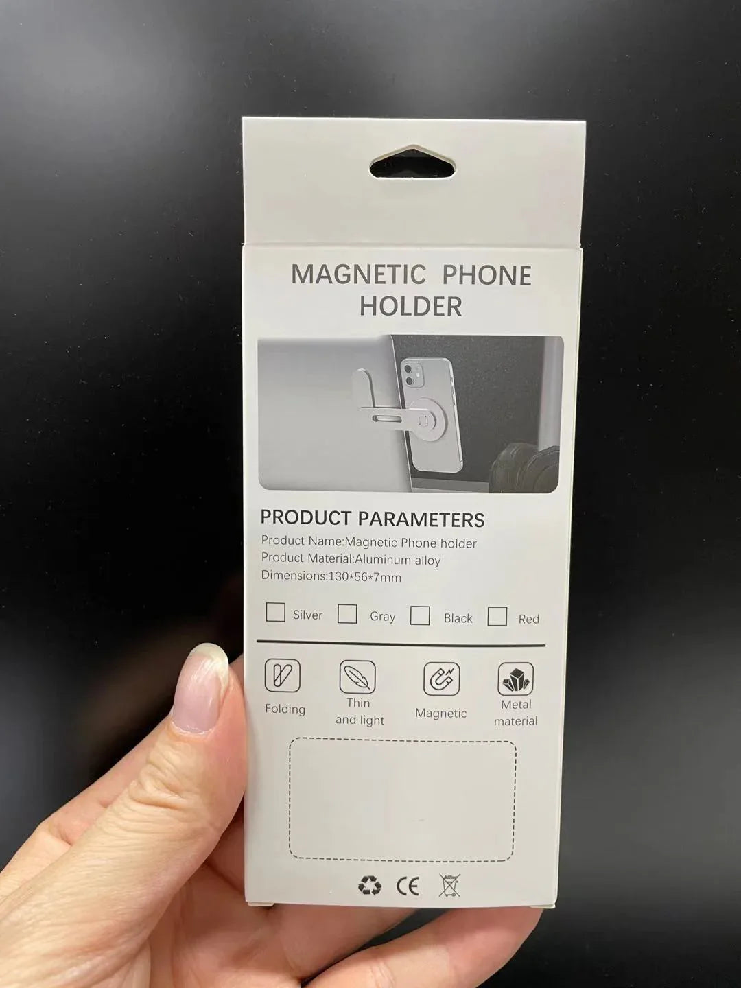 Laptop cell phone mount attached to notebook screen, showing easy magnetic suction feature.