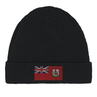 Close-up of a green cotton beanie with a Bermuda flag patch on the front